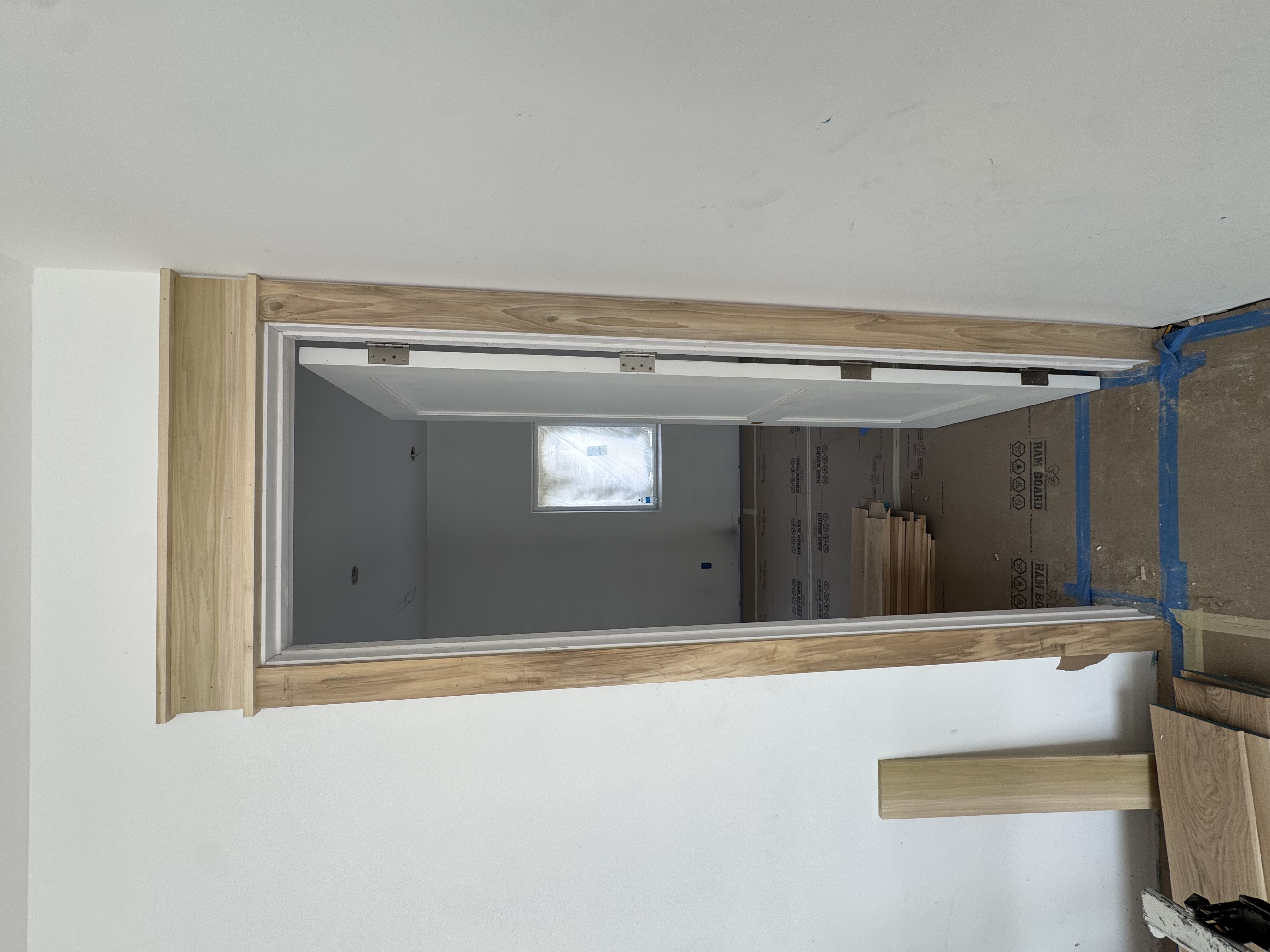Interior door hung and wrapped in custom wood casing