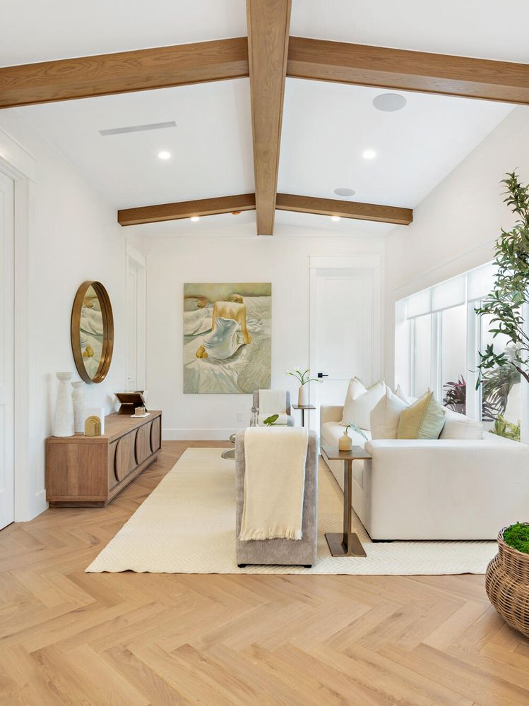 Stained wood ceiling beams crossing a white vaulted ceiling in a West Palm Beach living room