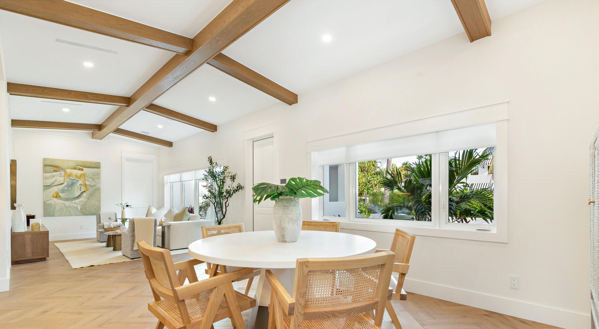 Grid of stained wood beams over a dining area with white walls, West Palm Beach