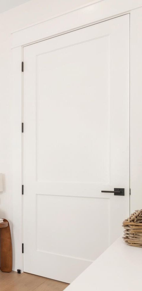 White two-panel interior door with black lever, hung and cased, West Palm Beach