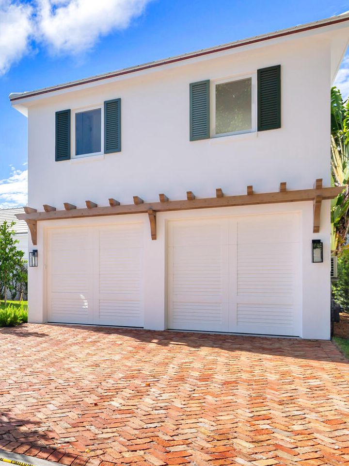 Custom wall-mounted wood pergola above a two-car garage, West Palm Beach