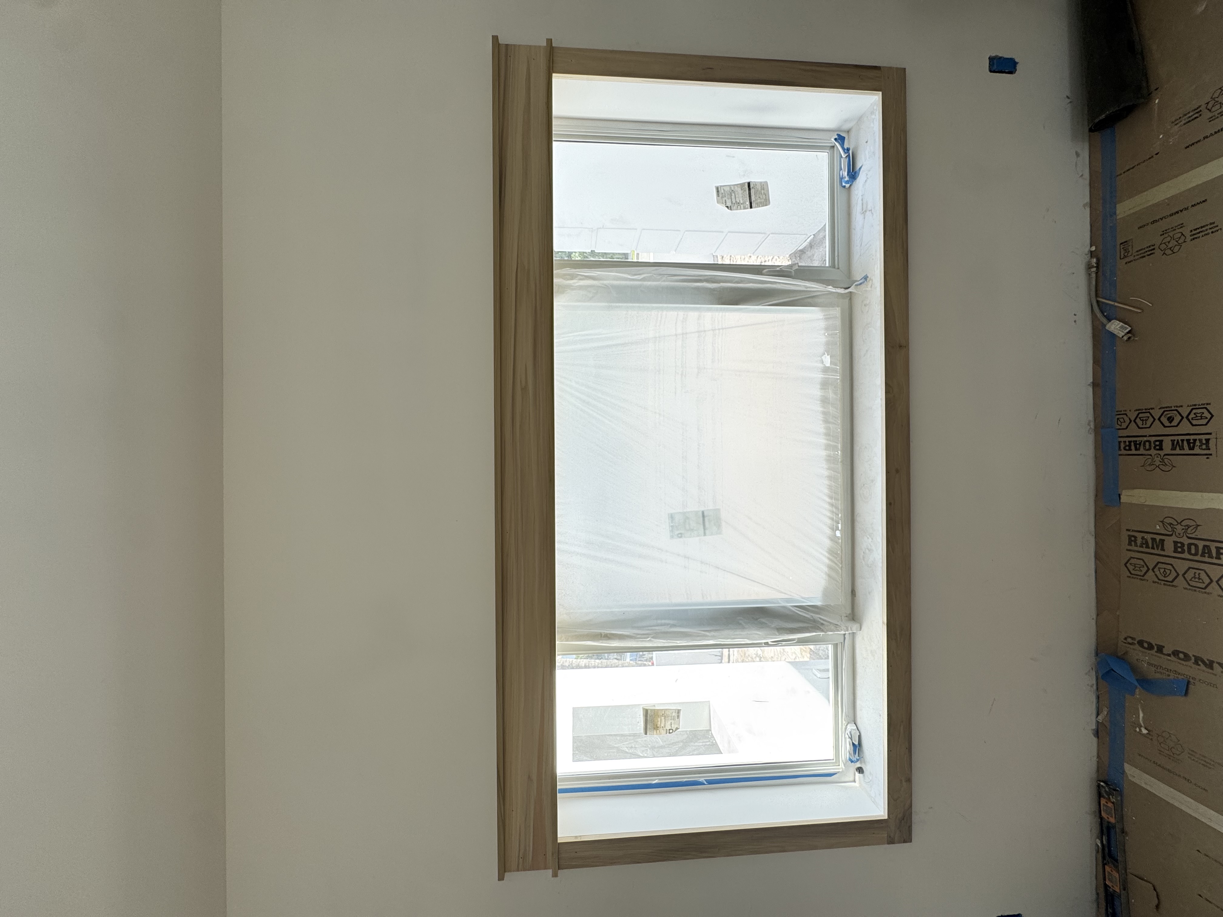 Natural wood window casing with header and sill